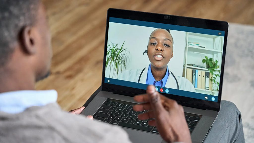 Patient having a virtual meeting with a doctor on his laptop.